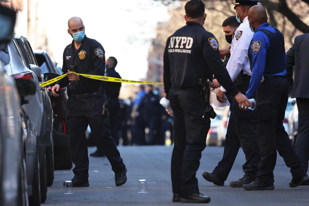 NYPD officers respond to the scene of a shooting that left multiple people injured in the Flatbush neighborhood of the Brooklyn borough in New York City on April 6, 2021. (Michael M. Santiago/Getty Images)