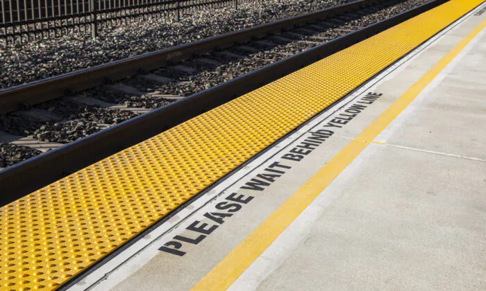 A train station waiting line in Orange, Calif., on Nov. 12, 2021. (John Fredricks/The Epoch Times)