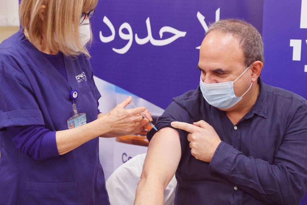 An Israeli man receives a fourth dose of the Pfizer-BioNTech COVID-19 coronavirus vaccine , as the Israeli hospital conducts a trial of the vaccine's fourth jab on staff volunteers, at the Sheba Medical Center in Ramat Gan near Tel Aviv, on Dec. 27, 2021. (Jack Guez/AFP via Getty Images)
