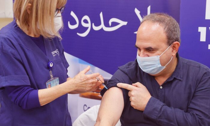 An Israeli man receives a fourth dose of the Pfizer-BioNTech COVID-19 coronavirus vaccine , as the Israeli hospital conducts a trial of the vaccine's fourth jab on staff volunteers, at the Sheba Medical Center in Ramat Gan near Tel Aviv, on Dec. 27, 2021. (Jack Guez/AFP via Getty Images)