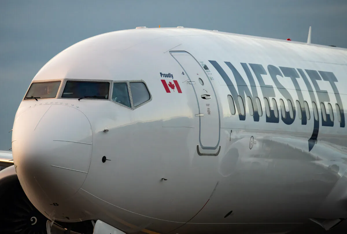 A WestJet Airlines aircraft taxis to a gate at Vancouver International Airport in Richmond, B.C., Jan. 21, 2021. (The Canadian Press/Darryl Dyck)
