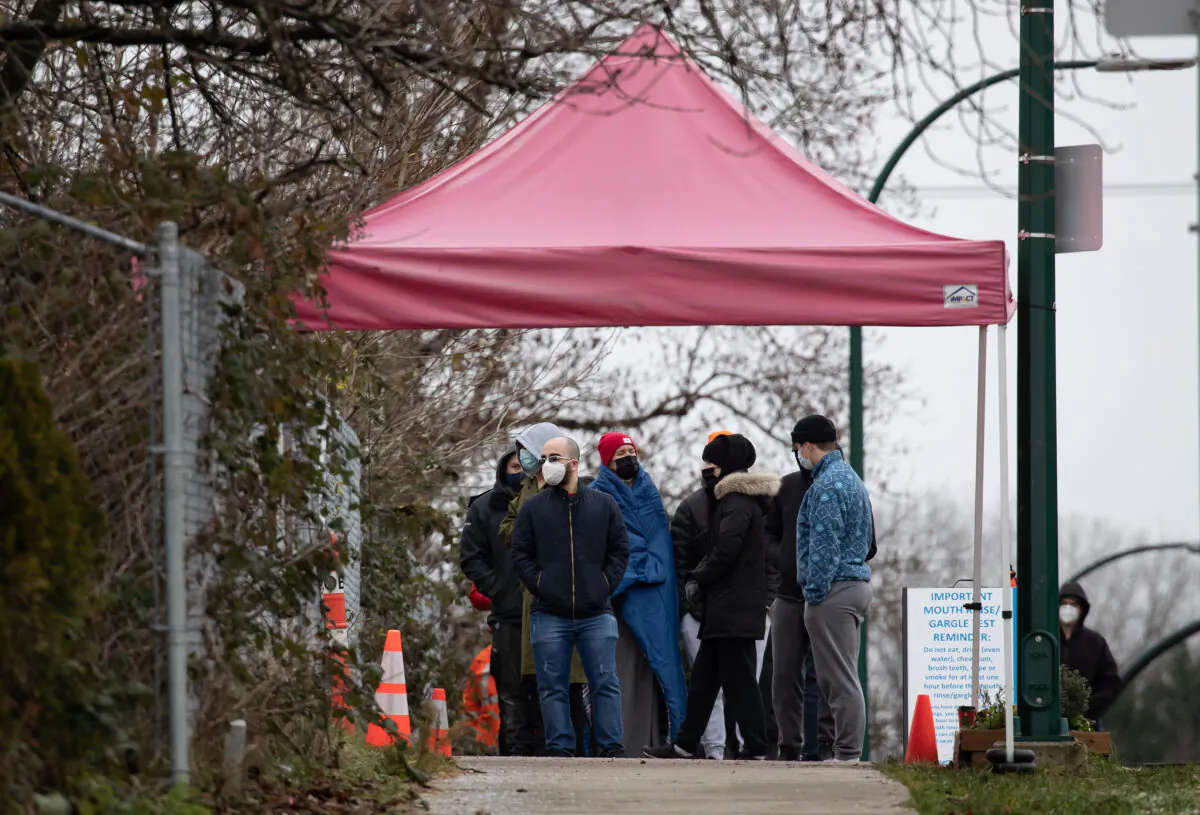 People wait in an hours-long lineup for a PCR test at a Vancouver Coastal Health COVID-19 drive-thru and walk-up testing site, in Vancouver, December 21, 2021. (The Canadian Press/Darryl Dyck)
