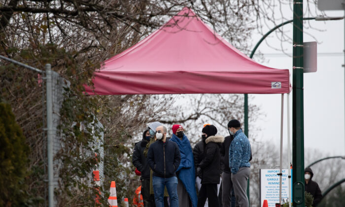 People wait in an hours-long lineup for a PCR test at a Vancouver Coastal Health COVID-19 drive-thru and walk-up testing site, in Vancouver, December 21, 2021. (The Canadian Press/Darryl Dyck)