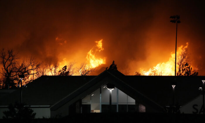 Flames explode as wildfires burned near a small shopping center near Broomfield, Colo., on Dec. 30, 2021. (AP Photo/David Zalubowski)