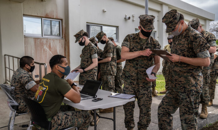 United States Marines register their details as they queue to receive the Moderna COVID-19 vaccine at Camp Hansen on April 28, 2021 in Kin, Japan. (Carl Court/Getty Images)