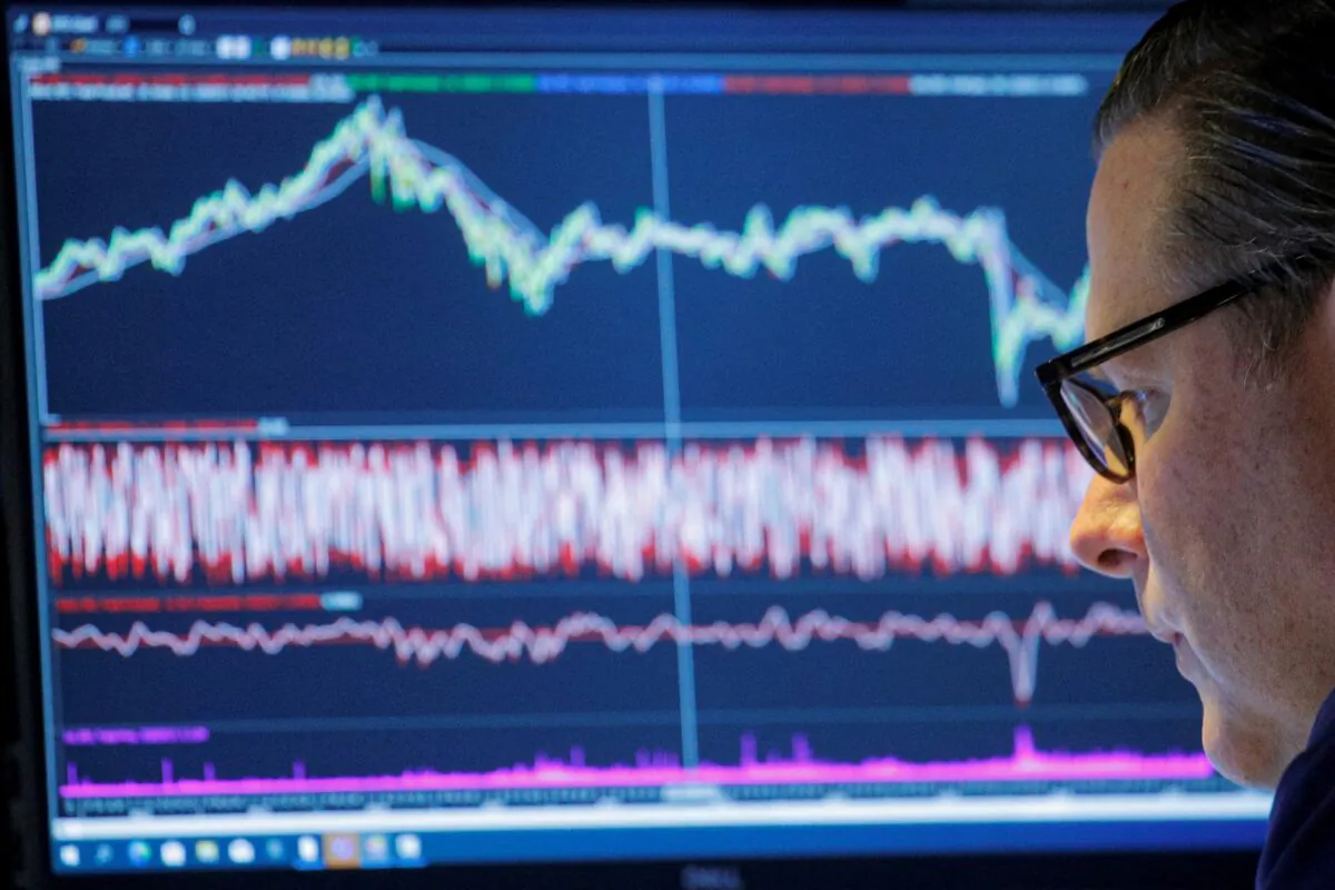 A trader works inside a booth on the floor of the New York Stock Exchange (NYSE) in New York on Nov. 8, 2021. (Brendan McDermid/Reuters)