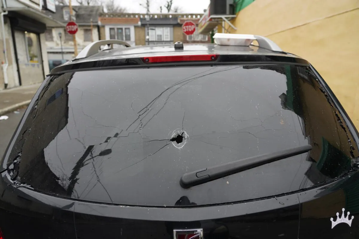 Parked vehicles are seen with bullet holes in the rear window, in Philadelphia on  Dec. 31, 2021. (Michael Perez/AP Photo)