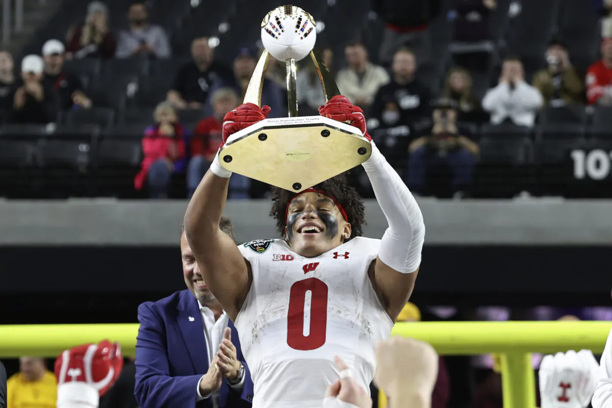 Wisconsin running back Braelon Allen (0) holds up the trophy, after Wisconsin defeated Arizona State in the Las Vegas Bowl NCAA college football game in Las Vegas on Dec. 30, 2021. (L.E. Baskow/AP Photo)