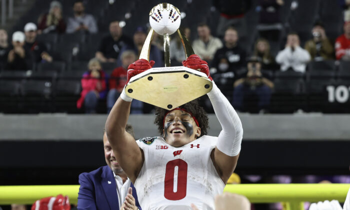 Wisconsin running back Braelon Allen (0) holds up the trophy, after Wisconsin defeated Arizona State in the Las Vegas Bowl NCAA college football game in Las Vegas on Dec. 30, 2021. (L.E. Baskow/AP Photo)