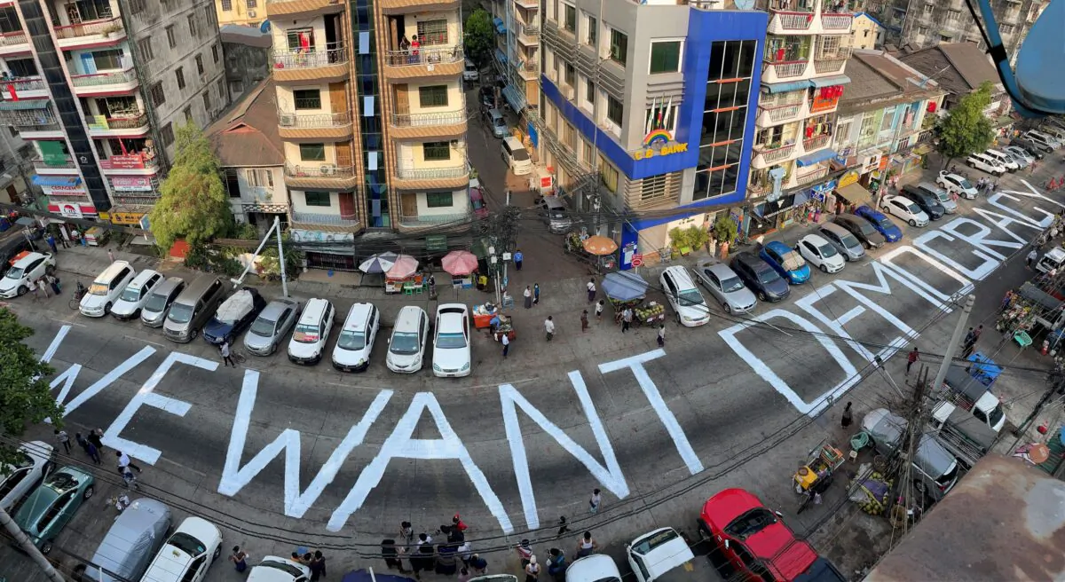 A slogan is written on a street as a protest after the coup in Yangon, Burma, on Feb. 21, 2021. (Stringer/Reuters)