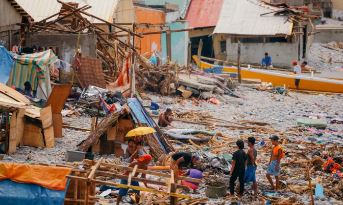 Residents build makeshift shelters following the destruction of their houses due to typhoon Rai, in Surigao City, Surigao del Norte, Philippines, on Dec. 21, 2021. (Jilson Tiu/Greenpeace/Handout via Reuters)