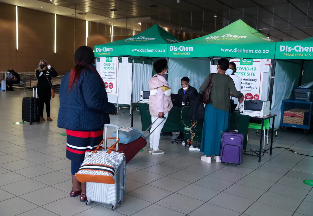 Passengers queue to get a PCR test against COVID-19 before traveling on international flights, at O.R. Tambo International Airport in Johannesburg, South Africa, on Nov. 26, 2021. (Sumaya Hisham/Reuters)