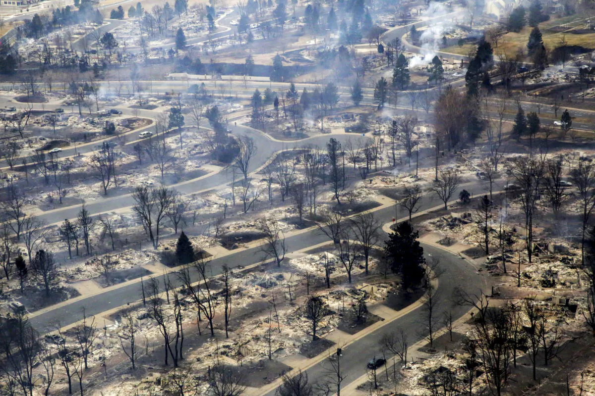 A view of a Boulder County neighborhood that was destroyed by a wildfire is seen from a Colorado National Guard helicopter, during a flyover by Gov. Jared Polis, on Dec. 31, 2021. (Hart Van Denburg/Colorado Public Radio via AP)