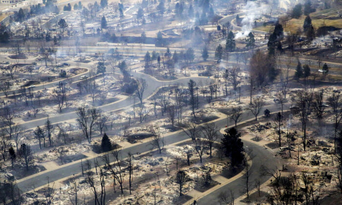 A view of a Boulder County neighborhood that was destroyed by a wildfire is seen from a Colorado National Guard helicopter, during a flyover by Gov. Jared Polis, on Dec. 31, 2021. (Hart Van Denburg/Colorado Public Radio via AP)
