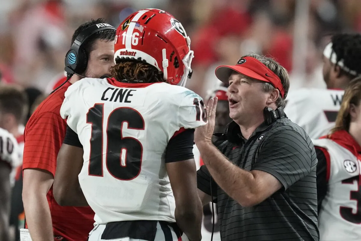 Georgia head coach Kirby Smart talks with defensive back Lewis Cine, during an NCAA game against Michigan, in Miami Gardens, Fla., on Dec. 31, 2021. (Rebecca Blackwell/AP Photo)