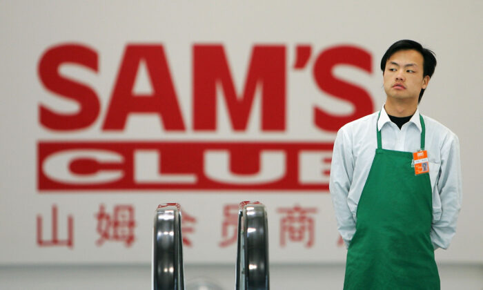 A worker goes up the escalator at Sam's Club, the first branch of a Walmart owned store in Beijing on Dec. 9, 2004. (Cancan Chu/Getty Images)