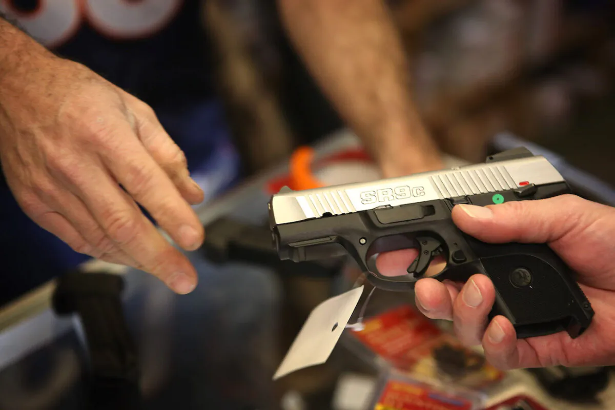 A customer shops for a pistol at Freddie Bear Sports sporting goods store in Tinley Park, Ill., on Dec. 17, 2012. (Scott Olson/Getty Images)