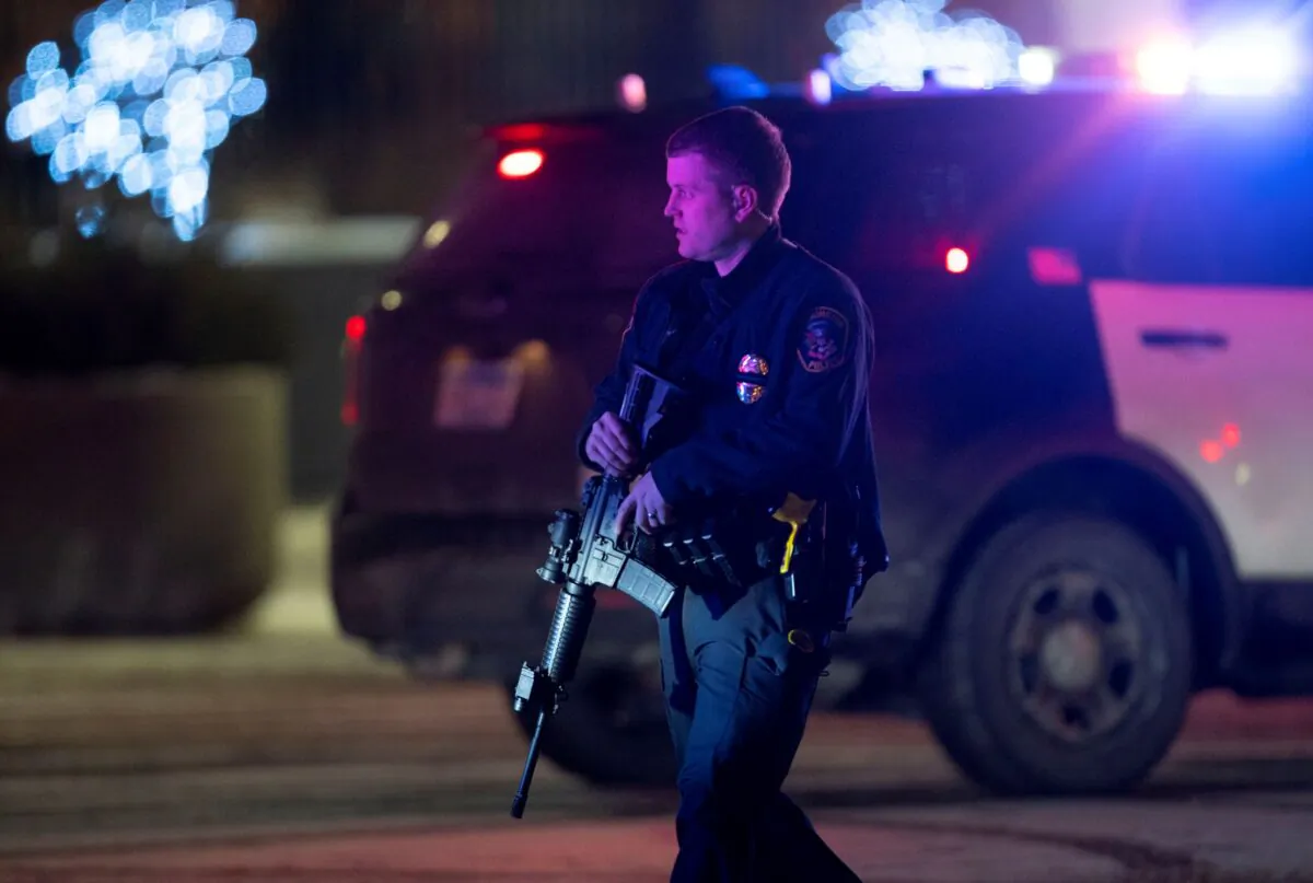A police officer carrying a rifle exits the Mall of America following a shooting, in Bloomington, Minn., on Dec. 31, 2021. (Alex Kormann/Star Tribune via AP)
