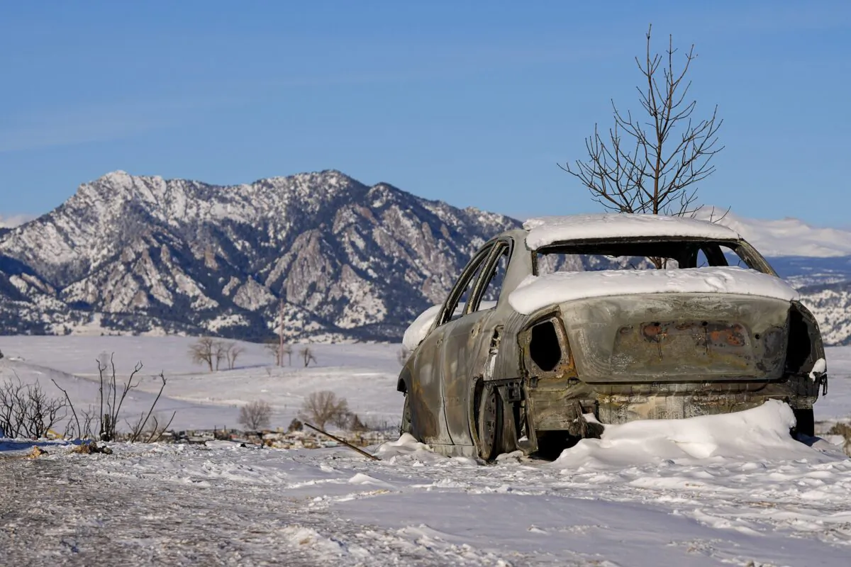 Snow covers the burned remains of a car after wildfires ravaged the area, in Superior, Colo., on Jan. 2, 2022. (Jack Dempsey/AP Photo)