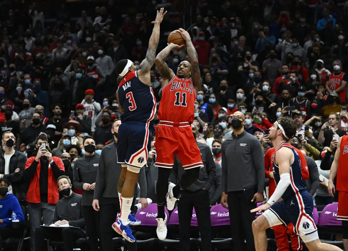 Chicago Bulls forward DeMar DeRozan (11) hits a game winning three point shot over Washington Wizards guard Bradley Beal (3) during the second half at Capital One Arena in Washington, on Jan 1, 2022. (Brad Mills-USA TODAY Sports via Field Level Media)