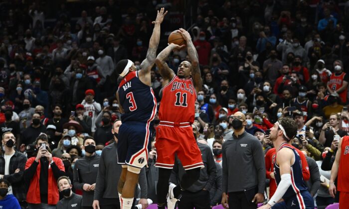 Chicago Bulls forward DeMar DeRozan (11) hits a game winning three point shot over Washington Wizards guard Bradley Beal (3) during the second half at Capital One Arena in Washington, on Jan 1, 2022. (Brad Mills-USA TODAY Sports via Field Level Media)