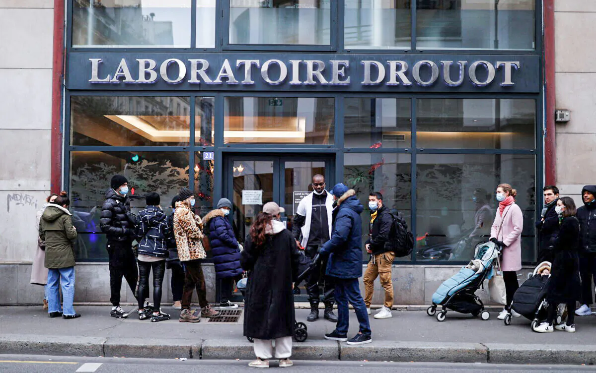 People queue for COVID-19 tests ahead of Christmas, in Paris, on Dec. 23, 2021. (Christian Hartmann/Reuters)