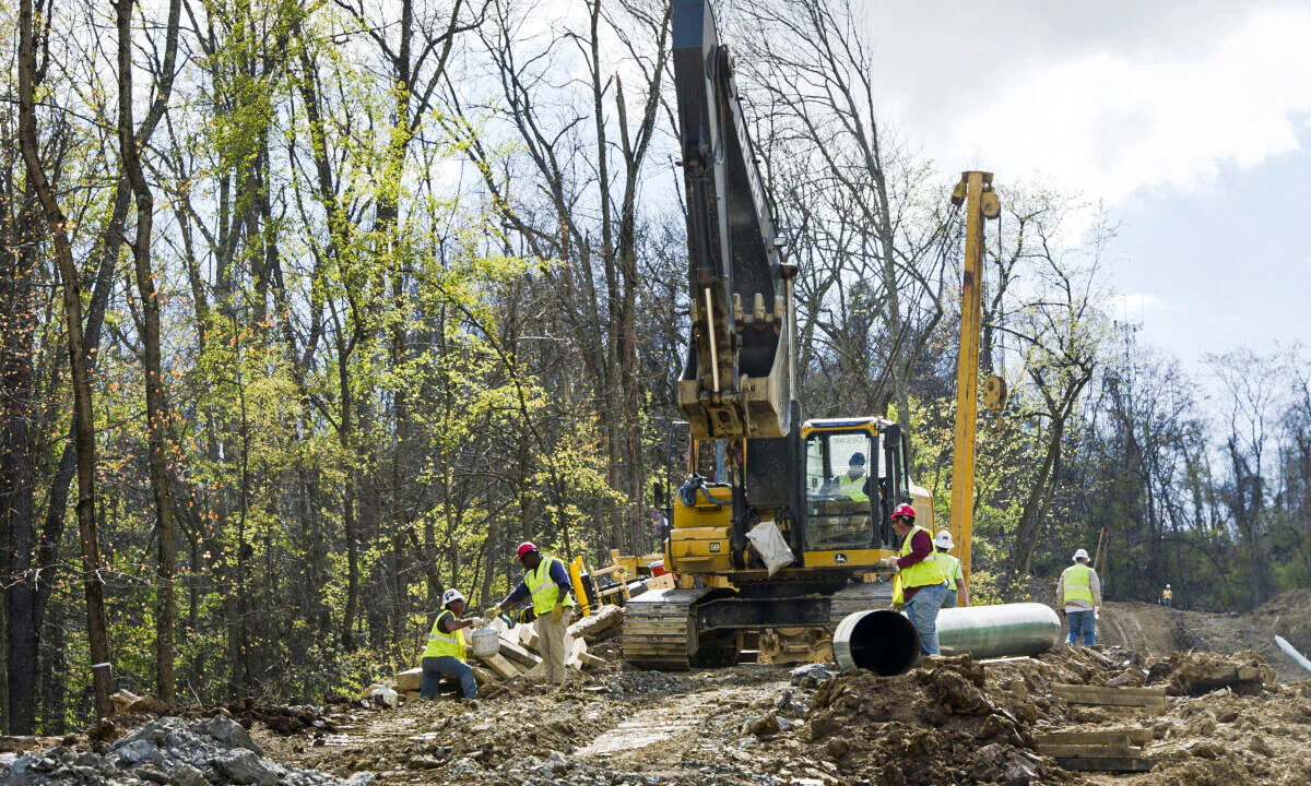 Workers lay the pipes of a gas pipeline outside the town of Waynesburg, Penn., on April 13, 2012. (Mladen Antonov/AFP via Getty Images)