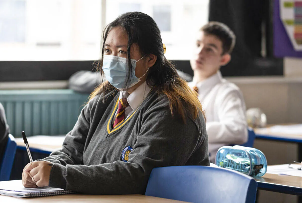 A child wearing a mask listens during a geography lesson at Whitchurch High School in Cardiff, Wales, on Sept. 14, 2021. (Matthew Horwood/Getty Images)