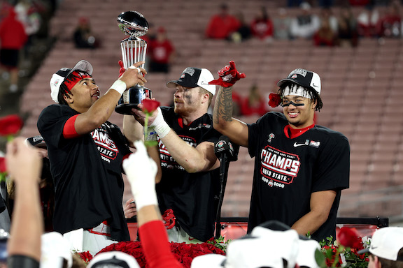 (L-R) C.J. Stroud #7, Tommy Eichenberg #35 and Jaxon Smith-Njigba #11 of the Ohio State Buckeyes raise the trophy after defeating the Utah Utes 48–45 in the Rose Bowl Game at Rose Bowl Stadium, in Pasadena, Calif., on Jan. 1, 2022. (Sean M. Haffey/Getty Images)