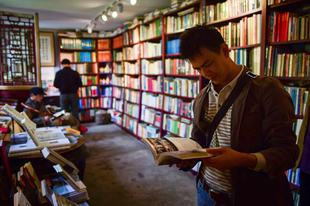 A man reads a book at a book store on World Book Day and Copyright Day in Beijing on April 23, 2018. (Wang Zhao/AFP via Getty Images)
