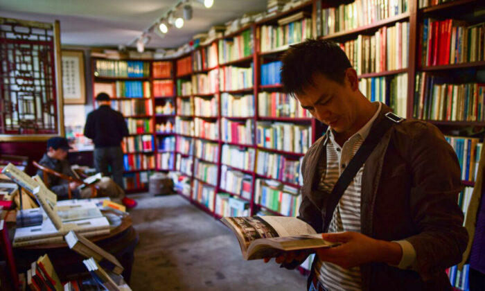 A man reads a book at a book store on World Book Day and Copyright Day in Beijing on April 23, 2018. (Wang Zhao/AFP via Getty Images)