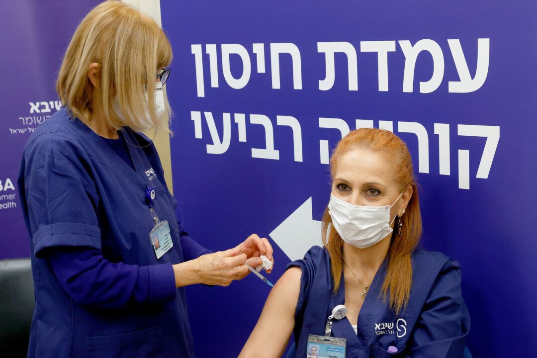 An Israeli nurse receives a fourth dose of the Pfizer-BioNTech COVID-19 vaccine at the Sheba Medical Center in Ramat Gan near Tel Aviv, on Dec. 27, 2021. (Jack Guez/AFP via Getty Images)
