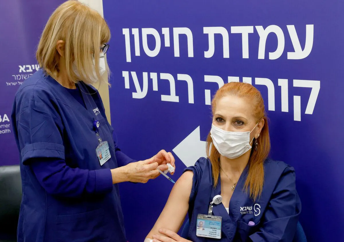 An Israeli nurse receives a fourth dose of the Pfizer-BioNTech COVID-19 vaccine at the Sheba Medical Center in Ramat Gan near Tel Aviv, on Dec. 27, 2021. (Jack Guez/AFP via Getty Images)