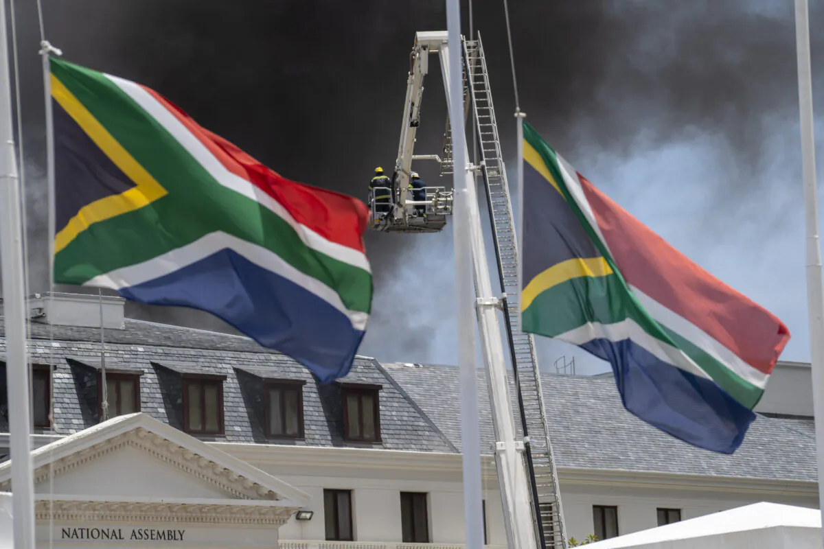 Firemen spray water on flames erupting from a building at South Africa's Parliament in Cape Town on Jan. 2, 2022. (Jerome Delay/AP Photo)