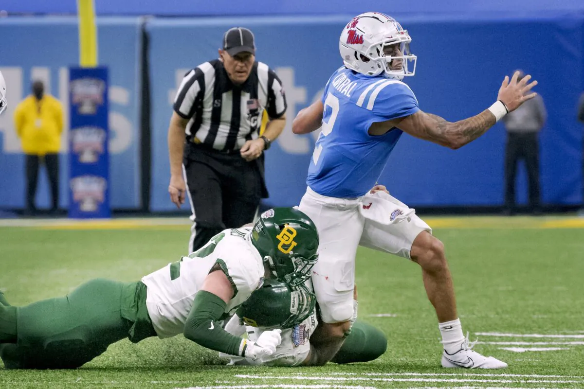 Mississippi quarterback Matt Corral (2) is tackled by Baylor defensive tackle Cole Maxwell (96) and linebacker Matt Jones (52) during the first half of the Sugar Bowl NCAA college football game in New Orleans, on Jan. 1, 2022. (Matthew Hinton/AP Photo)