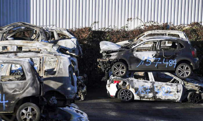 Burnt-out cars collected by city employees after the New Year's eve in the eastern French city of Strasbourg on Jan. 1, 2022. (Frederick Florin/AFP via Getty Images)