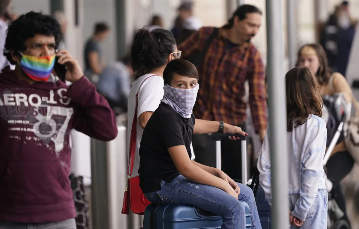 Travelers at Love Field in Dallas, Texas, on Dec. 31, 2021. (AP Photo/LM Otero)