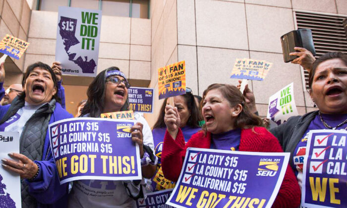 Service Employees International Union members celebrate after California Governor Jerry Brown signed landmark legislation SB 3 into law in Los Angeles, Calif. on April 4, 2016. (David McNew/Getty Images)