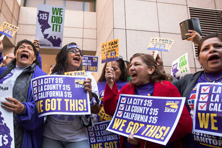 Service Employees International Union members celebrate after California Gov. Jerry Brown signed minimum wage legislation SB 3 into law in Los Angeles on April 4, 2016. (David McNew/Getty Images)
