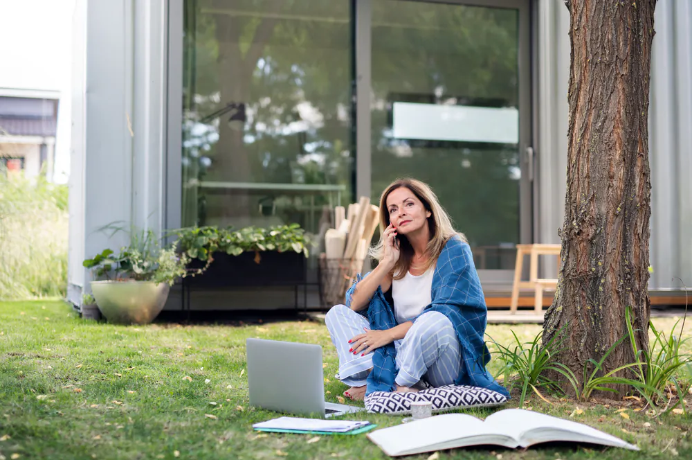 Resolve to enjoy your garden more, whether by eating outside, inviting friends and family over, or simply taking a stroll to smell the roses. (Halfpoint/Shutterstock)