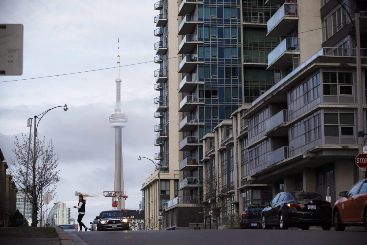 The CN Tower can be seen behind condo's in Toronto's Liberty Village community in Toronto, Ontario, April 25, 2017. (The Canadian Press/Cole Burston)
