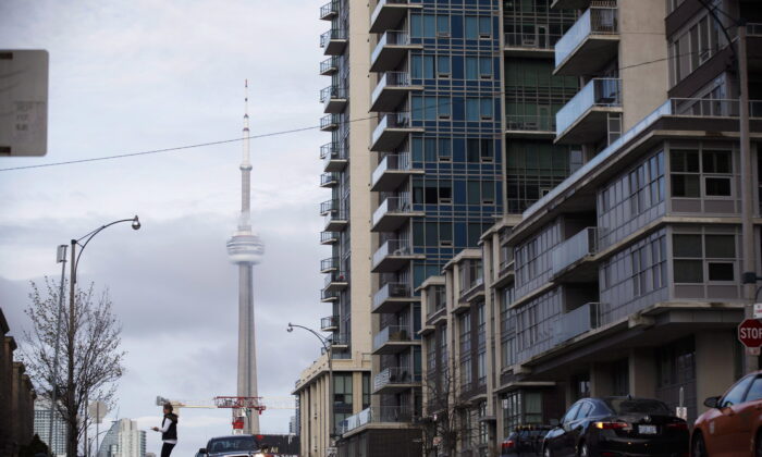 The CN Tower can be seen behind condo's in Toronto's Liberty Village community in Toronto, Ontario, April 25, 2017. (The Canadian Press/Cole Burston)