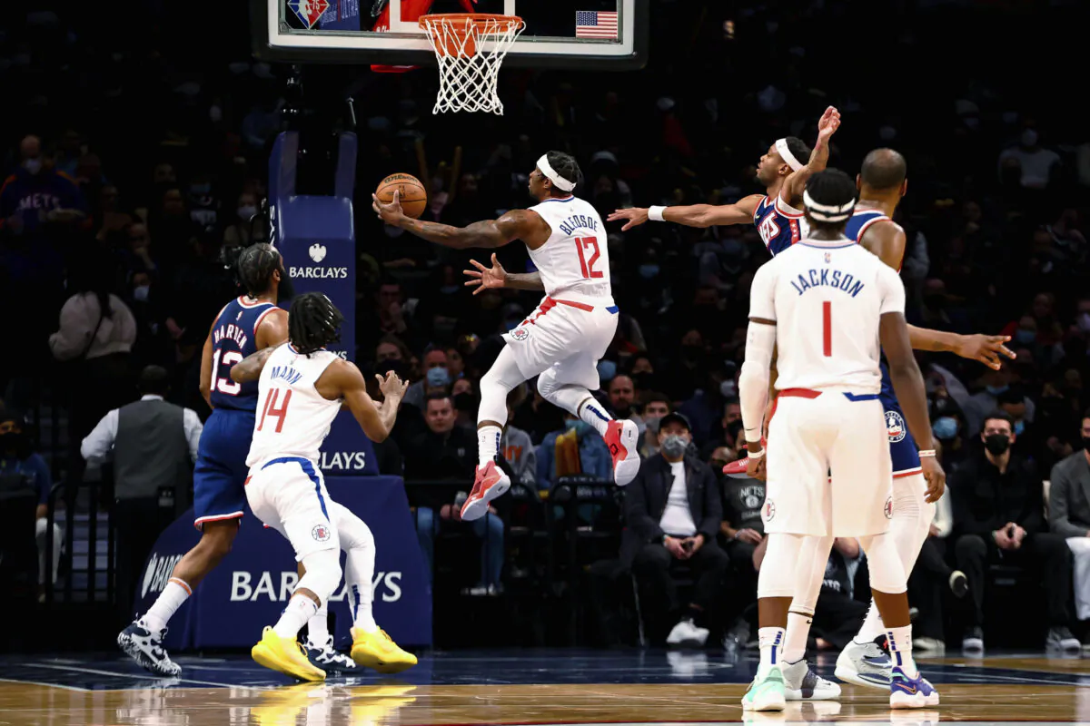 Los Angeles Clippers guard Eric Bledsoe (12) shoots against the Brooklyn Nets during the first half of an NBA basketball game in New York on Jan. 1, 2022. (AP Photo/Jessie Alcheh)