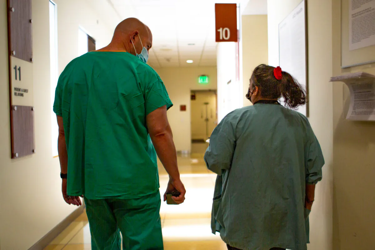 Hospital staff members walk down a hall in Orange., Calif., on Dec. 16, 2020. (John Fredricks/The Epoch Times)