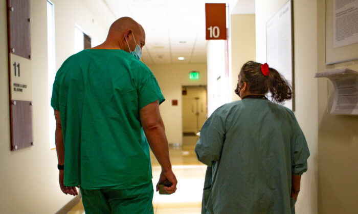Hospital staff members walk down a hall in Orange., Calif., on Dec. 16, 2020. (John Fredricks/The Epoch Times)