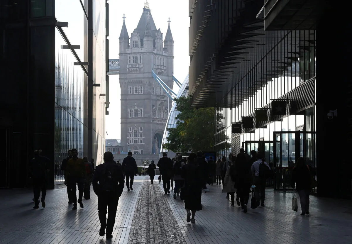 Workers walk towards Tower Bridge during the morning rush hour, amid a relaxation of lockdown restrictions during the COVID-19 pandemic in London on Sept. 15, 2021. (Toby Melville/Reuters)