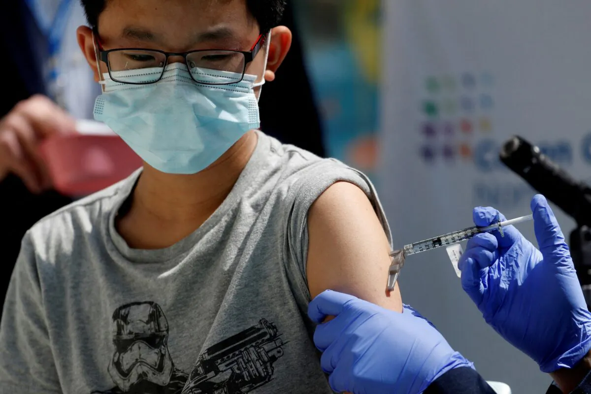 A 13-year-old boy gets the Pfizer-BioNTech COVID-19 vaccine at a medical center in New Hyde Park, N.Y., on May 13, 2021. (Shannon Stapleton/Reuters)
