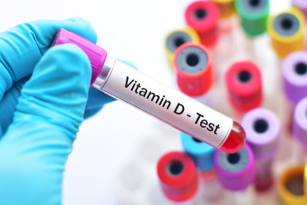 A pathologist holding up a vitamin D test. (Jarun Ontakrai/Shutterstock)