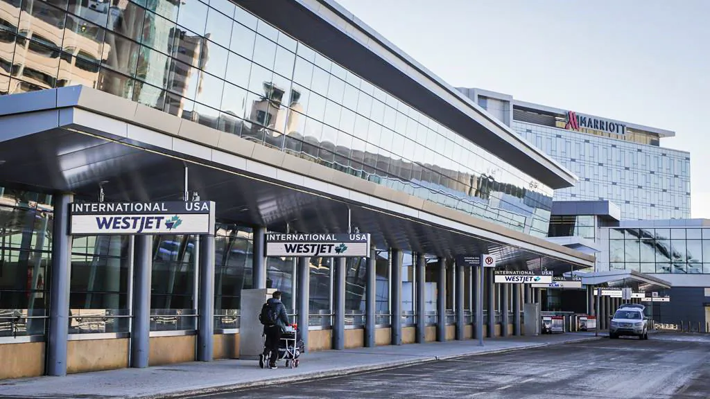A lone traveler enters the Calgary Airport in Calgary, Alta., Feb. 22, 2021. (The Canadian Press/Jeff McIntosh)