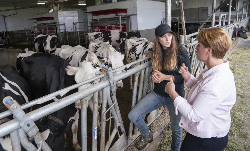 Marie-Claude Bibeau, Minister of Agriculture and Agri-Food, chats with farm owner Veronica Enright at her dairy farm in Compton, Que., Aug. 16, 2019. (The Canadian Press/Paul Chiasson)